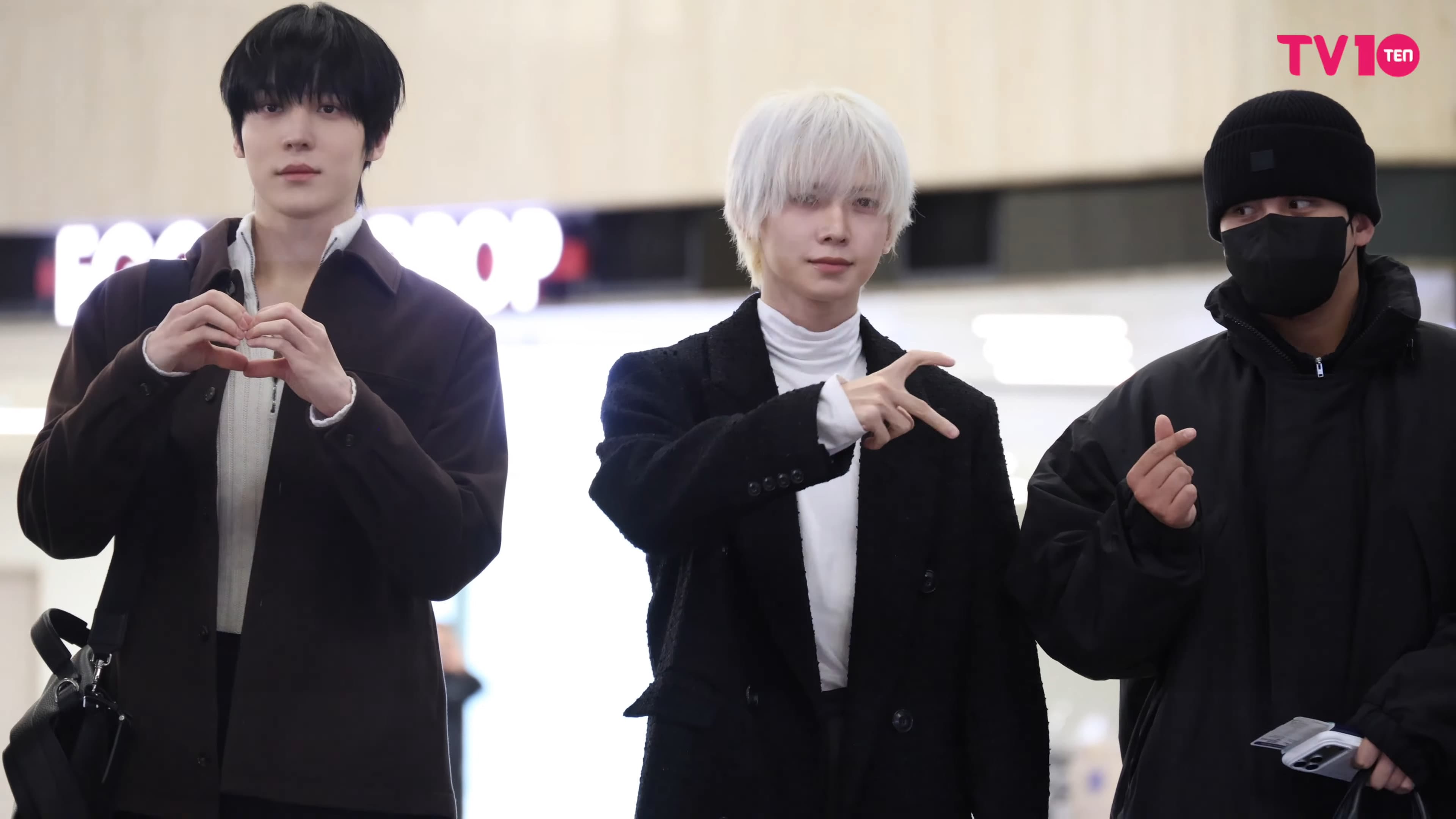 ATEEZ members moving through Gimpo airport in December 2025